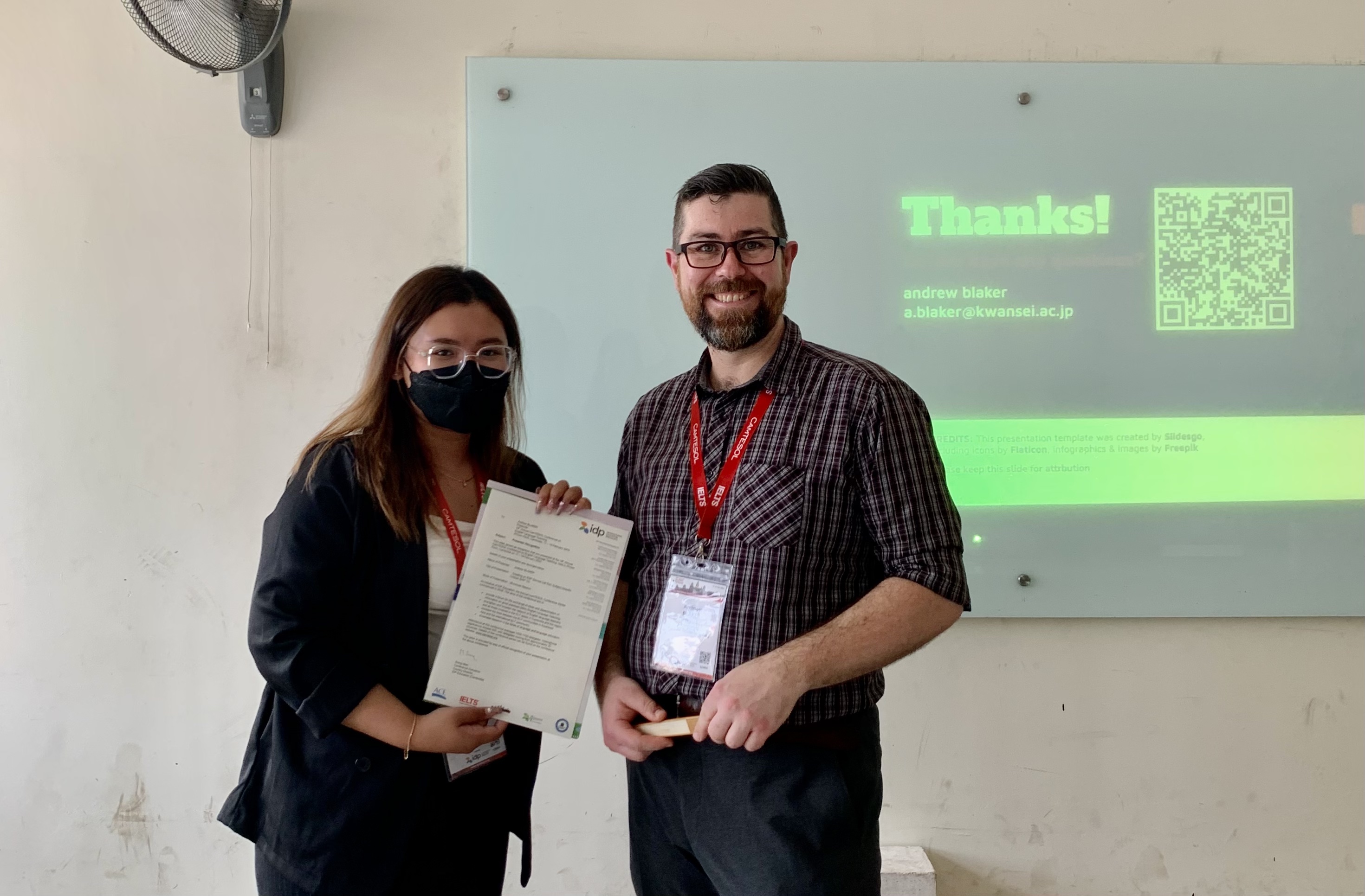 Andrew Blaker receiving a certificate of presentation at CamTESOL 2023